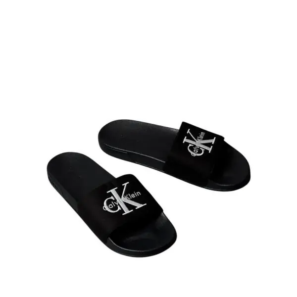 Calvin Klein - Ανδρικές Παντόφλες Slide Canvas Logo YM0YM01393-0GJ Μαύρο YM0YM01393-0GJ