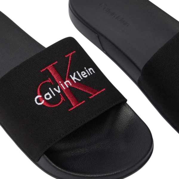 Calvin Klein - Ανδρικές Παντόφλες Slide Canvas Logo YM0YM01393-0KQ Μαύρο YM0YM01393-0KQ